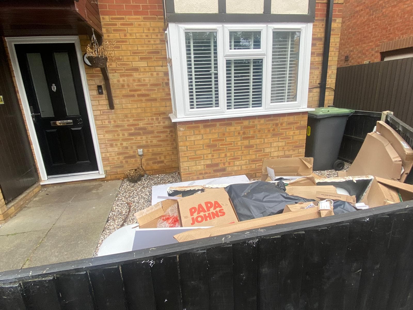 Cardboard and household waste piled up outside a house ready for collection