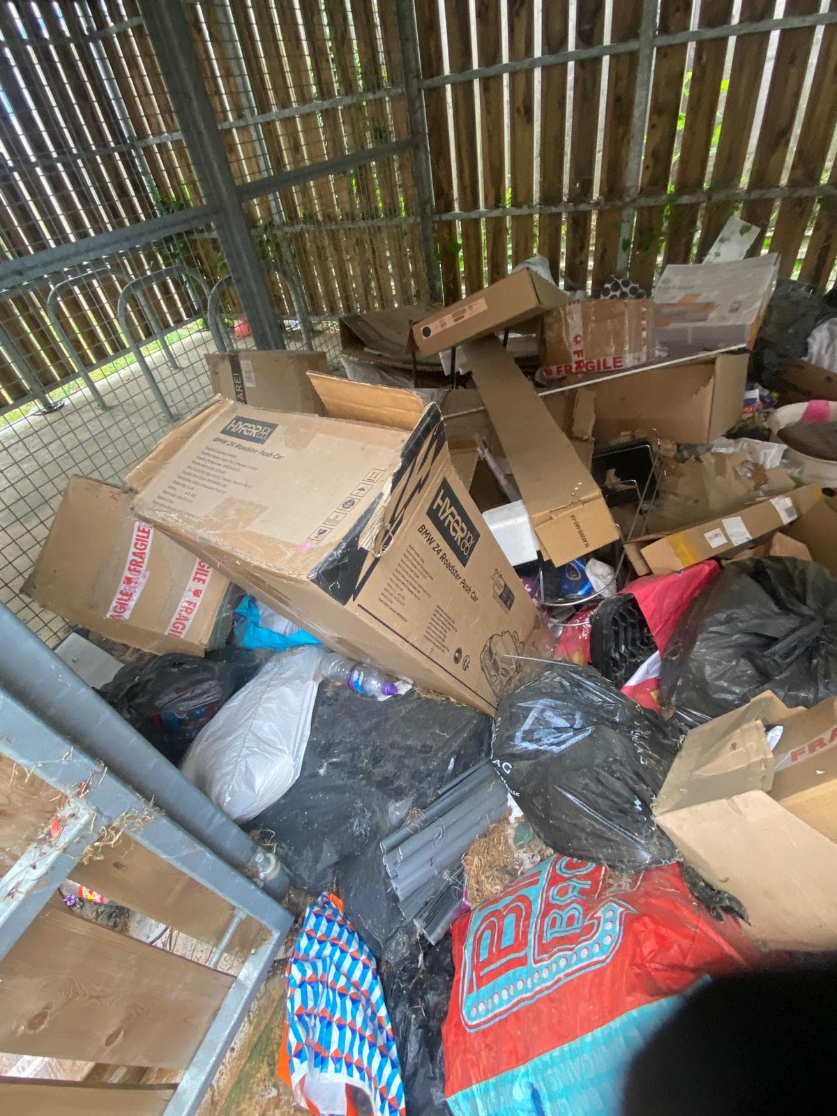 Bin store packed with cardboard and rubbish