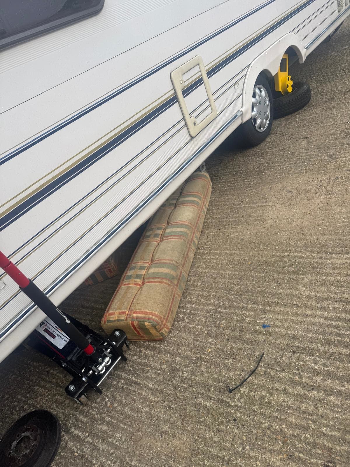Old sofa cushions and seating removed from underneath a caravan