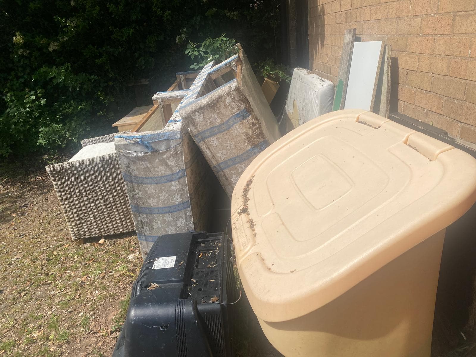Bulky waste pile cleared from a driveway, fly tip removal