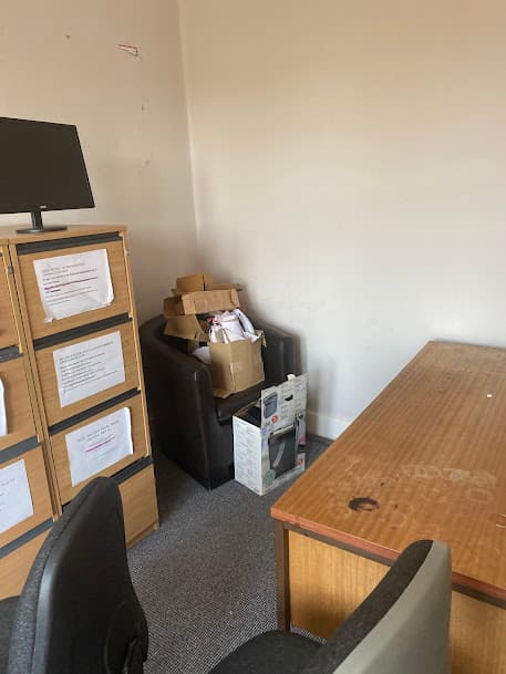 Office clear-out with furniture and boxes