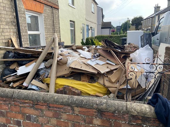 Fly tipped waste cleared from front garden wall