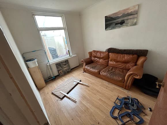 Living room with sofa before clearance
