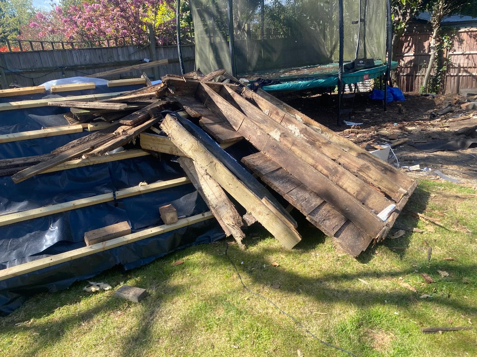 Decking and timber removed from a garden during a light demolition job